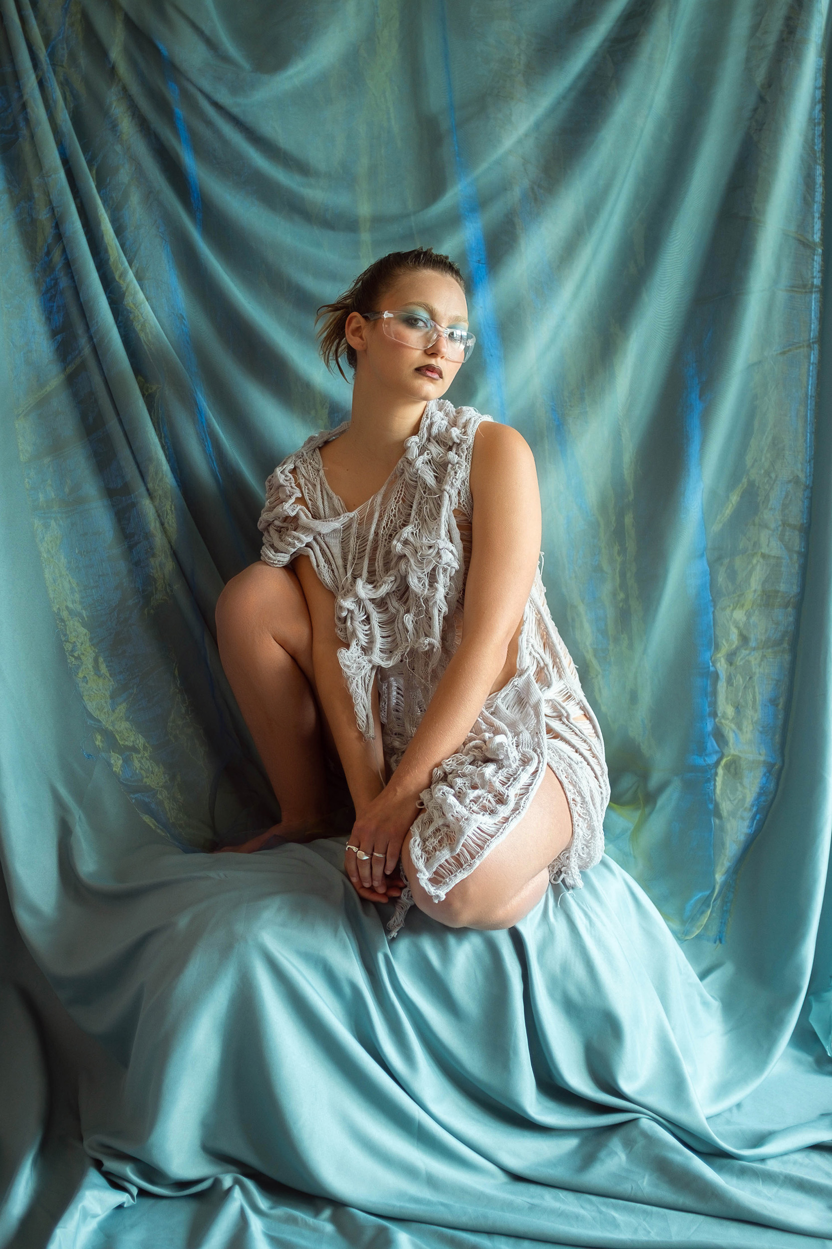 a woman sitting on a blue fabric